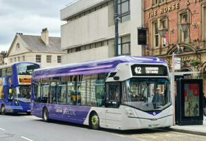 A couple of buses that are sitting in the street