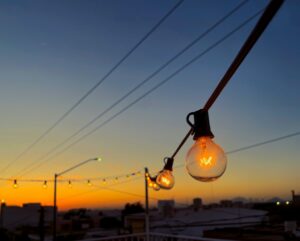 a string of light bulbs hanging from a power line