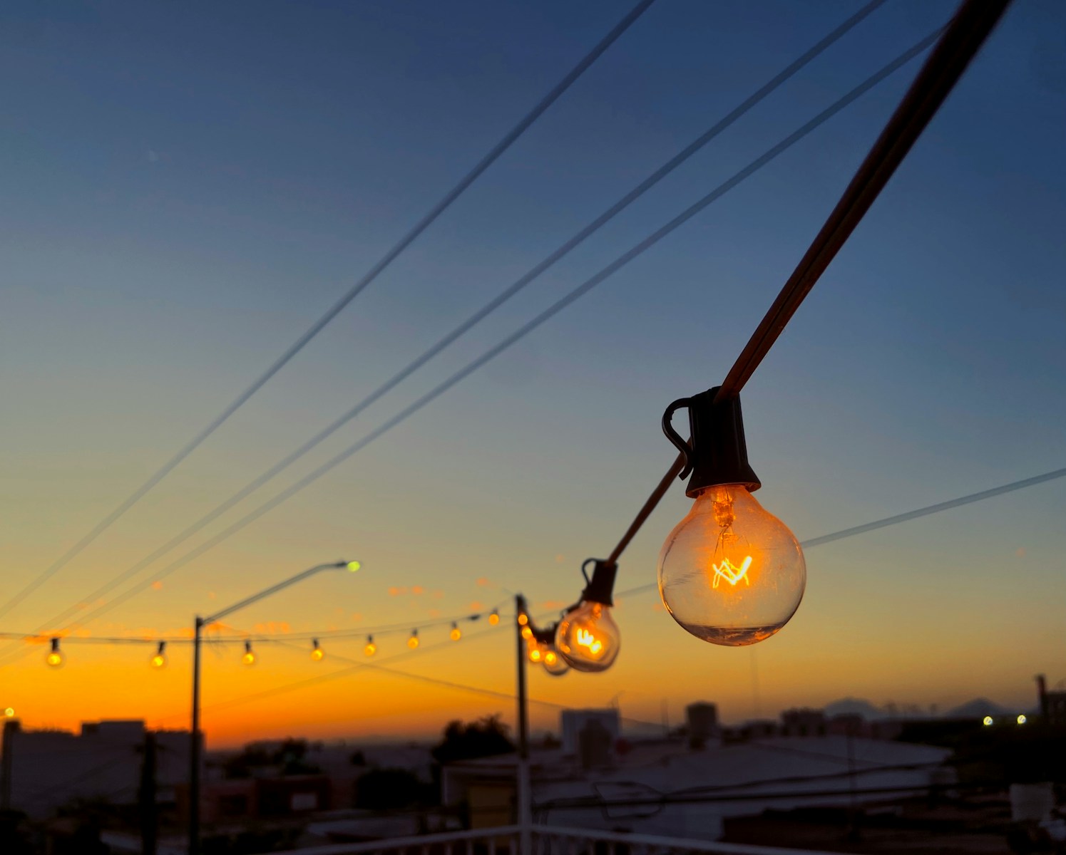 a string of light bulbs hanging from a power line